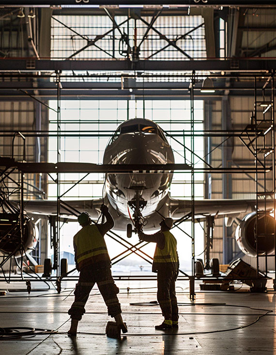 Aircraft maintenance with blow off system technicians in an industrial hangar
